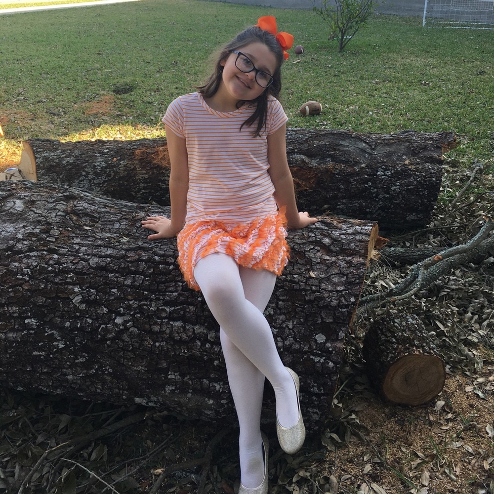 Cute girl’s orange and while T-shirt dress.